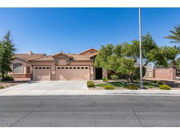 Charming single-story home features a three-car garage and well-manicured front yard with mature landscaping at 2200 Valley Heights Ave, Henderson, NV 89052