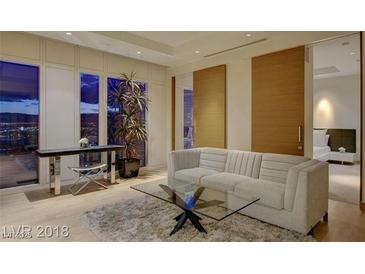 Bright living room features a comfortable sofa, glass coffee table and floor to ceiling windows with a city view at 3750 S Las Vegas Blvd # 3111, Las Vegas, NV 89158