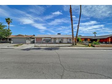 Charming single-story home with a gravel yard and mature palm trees at 4067 E Colorado Ave, Las Vegas, NV 89104