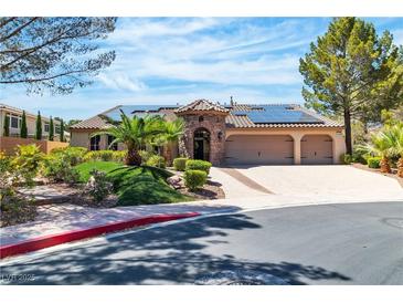 Charming single-story home with a three-car garage and well-manicured front yard landscaping at 4196 Balmoral Castle Ct, Las Vegas, NV 89141
