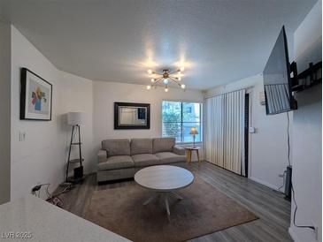 Inviting living room featuring modern lighting, neutral tones, and a comfortable seating arrangement at 460 Elm Dr # 103, Las Vegas, NV 89169