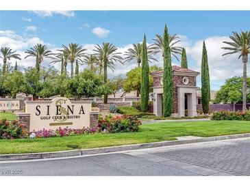 Landscaped entrance to Siena Golf Club & Bistro, featuring manicured lawns, colorful flowers, and towering palm trees at 4845 Santo Romeo St, Las Vegas, NV 89135