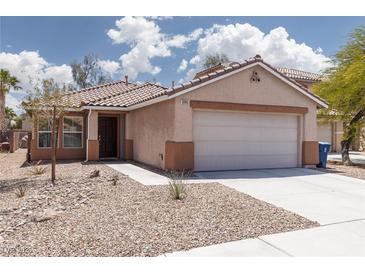 Inviting single story home featuring low-maintenance desert landscaping and attached two car garage at 5043 Naff Ridge Dr, Las Vegas, NV 89131