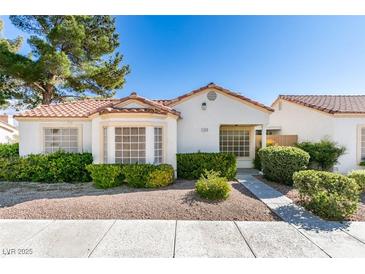 Charming single-story home with a tile roof and well-maintained landscaping with mature trees and gravel ground cover at 5424 Comchec Way # 105, Las Vegas, NV 89108