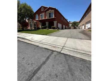 Charming two-story townhome with lush green lawn and attached garages at 805 Desert Oak Ct, Las Vegas, NV 89147