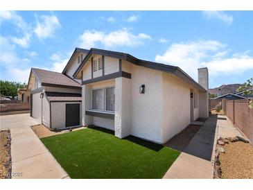 Charming single-story home featuring new artificial turf and modern exterior paint scheme at 806 Fireweed Dr, Henderson, NV 89002