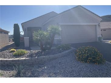 Single-story home featuring desert landscaping, a two-car garage, and a neutral color scheme at 2048 King Mesa Dr, Henderson, NV 89012