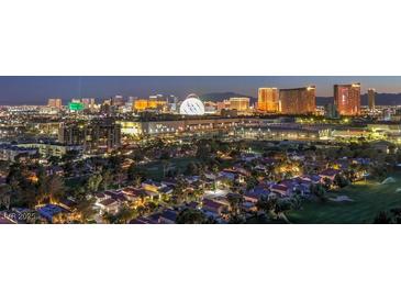 Panoramic aerial view of a residential area with the Las Vegas city skyline in the background at dusk at 3111 Bel Air Dr # 23A, Las Vegas, NV 89109