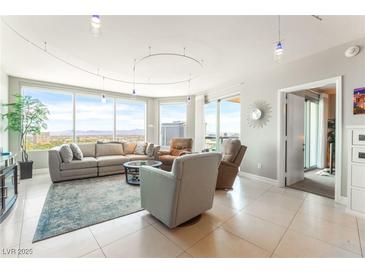 Bright living room featuring floor-to-ceiling windows and comfortable seating, perfect for entertaining at 322 Karen Ave # 2201, Las Vegas, NV 89109