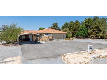 Charming ranch home with desert landscaping, orange tile roof and spacious driveway at 3360 National Ave, Pahrump, NV 89048