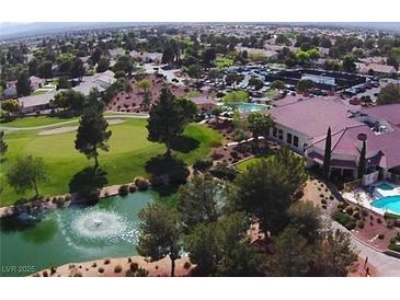 Stunning aerial view of a golf course community with a clubhouse, pool, and lush landscaping at 5028 Glenarden Dr, Las Vegas, NV 89130