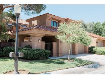 Inviting two-story home featuring a well-maintained front yard and a charming tiled roof at 7607 Boca Raton Dr, Las Vegas, NV 89113