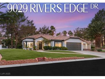 Charming single-story home with a well-manicured lawn, tile roof, and a two-car garage in a desirable neighborhood at 9029 Rivers Edge Dr, Las Vegas, NV 89117