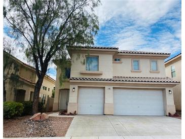 Two-story home with a two-car garage, landscaped front yard, and neutral-colored facade at 9821 Sedona Shrine Ave, Las Vegas, NV 89148