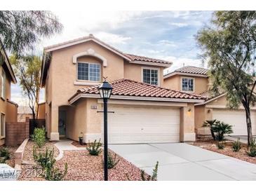 Two story home showcasing desert landscaping, a red tile roof, and a two car garage at 11029 Meadow Leaf Ave, Las Vegas, NV 89144