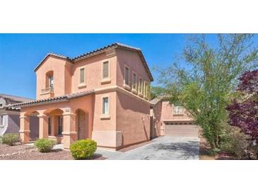 Charming two-story home features stucco siding, arched entryway, and well-maintained landscaping at 11274 Civita St, Las Vegas, NV 89141