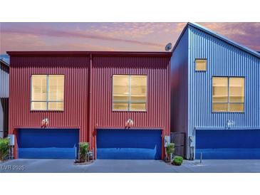 Stylish townhomes showcasing modern architecture with vibrant, complementary colors and private garage entrances at 1190 E Carson Ave, Las Vegas, NV 89101