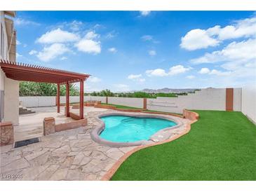 Backyard with a pergola covered patio, pool, and turf at 1611 Buffalo Trail Dr, Henderson, NV 89014