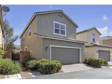 Charming two-story home features a gray exterior, a well-kept lawn, and a two-car garage at 3132 Cartanda Ave, Henderson, NV 89044