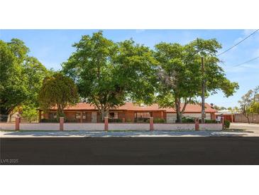Charming single-story home with mature trees and a brick perimeter wall at 3250 Duneville St, Las Vegas, NV 89146