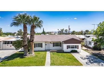 Charming single-story home with a well-maintained lawn and mature palm trees in a desirable neighborhood at 633 5Th St, Boulder City, NV 89005