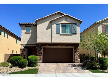 Charming two-story home with brick-accented facade, well-manicured landscaping, and a two-car garage at 6334 Orions Belt Peak St, North Las Vegas, NV 89031