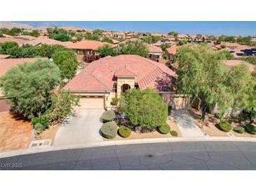 Stunning single-story home with a three-car garage, mature landscaping, and tile roof in a desirable community at 9092 National Park Dr, Las Vegas, NV 89178