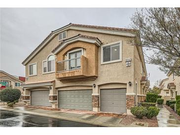 Charming townhome with private garages, a balcony and inviting curb appeal in a well-maintained community at 10147 Aspen Rose St # 101, Las Vegas, NV 89183