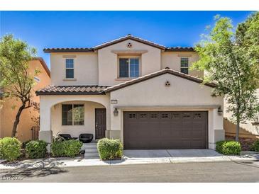 Charming two-story home with a well-manicured lawn and a two-car garage at 10353 Yew Blossom Ave, Las Vegas, NV 89166