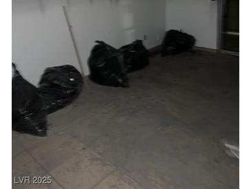 Living room needing renovation with trash bags and old floors at 1405 Vegas Valley Dr # 378, Las Vegas, NV 89169