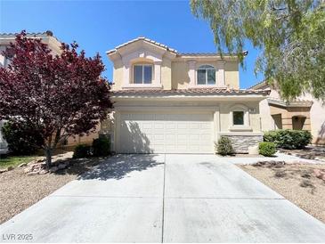 Charming two-story home features a two-car garage, well-maintained landscaping, and a welcoming facade at 180 Duck Hollow Ave, Las Vegas, NV 89148