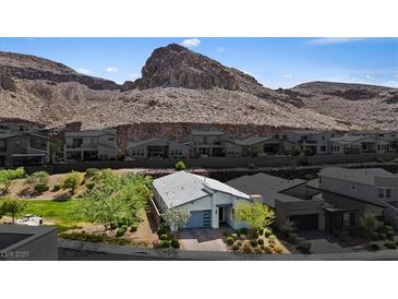 Charming single-story home with a well-manicured lawn set against a beautiful mountain backdrop at 1957 Regal Bluff Dr, Henderson, NV 89052