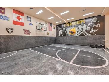 Indoor sports court featuring a basketball hoop, Vegas Golden Knights mural, and grey flooring at 2086 Troon Dr, Henderson, NV 89074