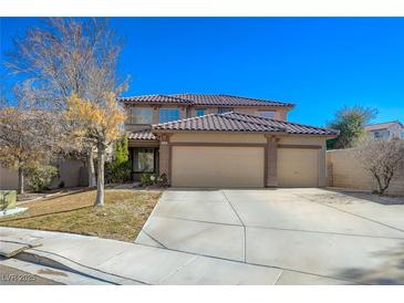 Charming two-story home featuring a well-manicured lawn and a spacious three-car garage at 3034 Scenic Valley Way, Henderson, NV 89052