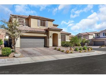 Two-story home with desert landscaping, tile roof, and a two car garage on a sunny day at 3512 Portiani Dr, Las Vegas, NV 89141