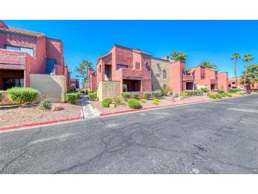 View of a modern apartment complex with beautifully landscaped grounds and inviting curb appeal at 4050 Pacific Harbors Dr # 245, Las Vegas, NV 89121