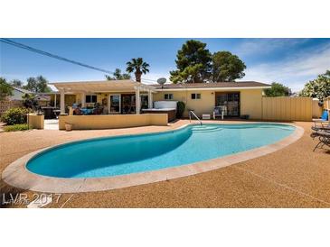 Inviting backyard pool with a relaxing hot tub and covered patio area, perfect for outdoor enjoyment at 502 E Fairway Rd, Henderson, NV 89015