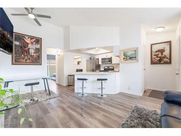 Bright living room featuring sleek floors, modern furnishings, and an open layout to the kitchen at 515 Kristin Ln, Henderson, NV 89011