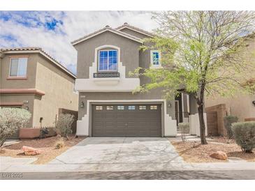 Charming two-story home with a well-maintained front yard and a two car garage in a suburban neighborhood at 9545 Parker Springs Ct, Las Vegas, NV 89166