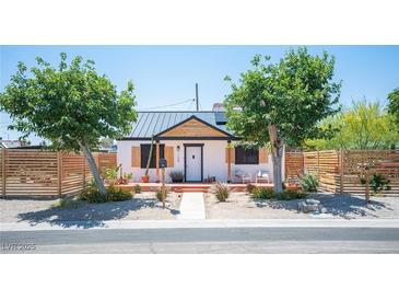 Charming single-story home with metal roof, white exterior, modern fence, and drought-tolerant landscaping at 108 Verdy Ln, Las Vegas, NV 89101