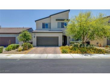 Contemporary two-story home featuring a two-car garage and modern landscaping at 1321 Hudson Creek Pl, North Las Vegas, NV 89084