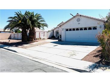 Charming single-story home with a well-maintained front yard, desert landscaping, and a two-car garage at 1860 Banaba Ln, Las Vegas, NV 89156