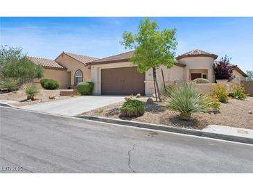 Charming single-story home featuring a landscaped front yard and a two-car garage at 2425 Sturrock Dr, Henderson, NV 89044