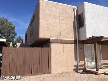 Two-story home featuring a partially fenced yard and a covered entryway with number 3435 visible on the side at 3435 Villa Knolls South Dr, Las Vegas, NV 89120