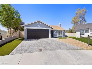 Charming single-story home with a well-manicured lawn and a paved driveway leading to a two-car garage at 6017 Montecito Way, Las Vegas, NV 89108