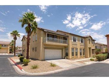 Two-story home with a balcony over the garage and a well-maintained front yard with palm trees at 8109 Retriever Ave, Las Vegas, NV 89147