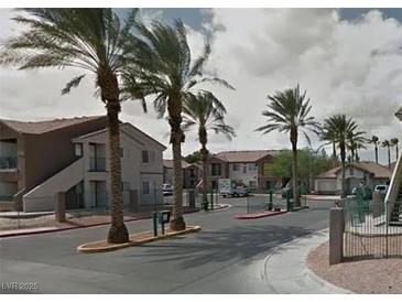 View of the community entrance with palm trees and well-maintained landscaping at 1505 Frank Aved St # 101, Las Vegas, NV 89110