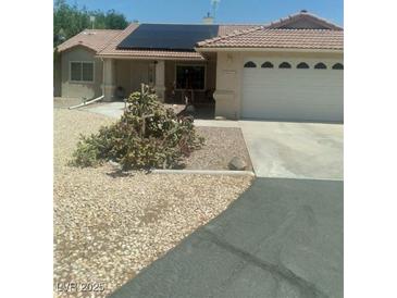 Charming single-story home featuring solar panels and a xeriscaped front yard for low maintenance at 1611 Red Rock Dr, Pahrump, NV 89048