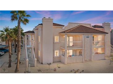 Charming condo features a stucco exterior, stairs to entry, and balcony perfect for enjoying the neighborhood views at 1928 Las Palmas Ln # 228, Laughlin, NV 89029