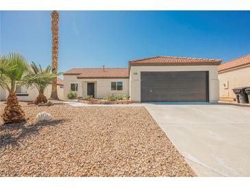 Charming single-story home with a well-maintained front yard and attached two car garage at 2719 Frangipani Ct, North Las Vegas, NV 89031